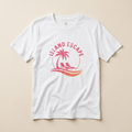 White t-shirt with 'Island Escape' graphic design featuring a palm tree and lounge chairs on a beige background.