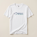 White t-shirt with 'Mentally at the Beach' text and palm tree graphics on a beige background