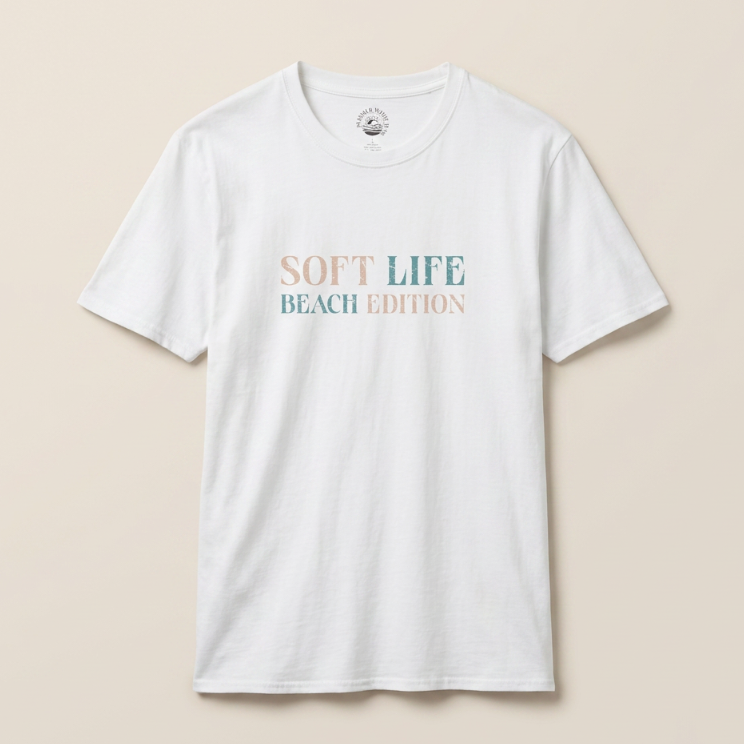 White t-shirt with 'Soft Life Beach Edition' text on a beige background