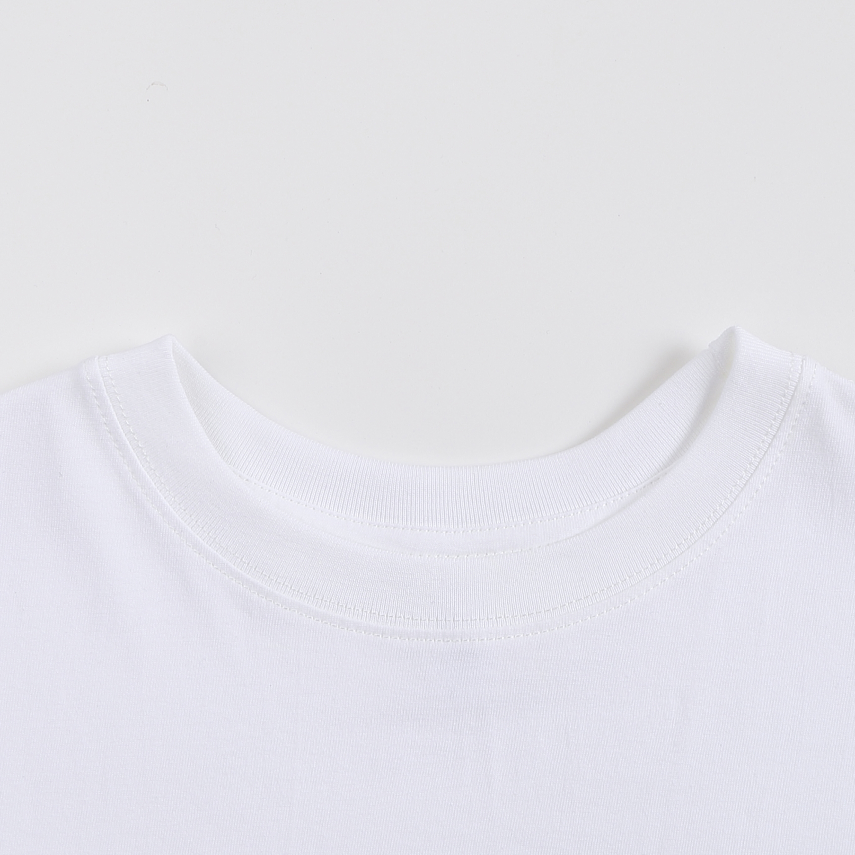 Close-up of a white t-shirt collar on a light gray background